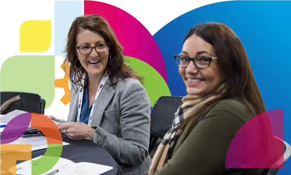 Two happy female professionals in HRWest conference

