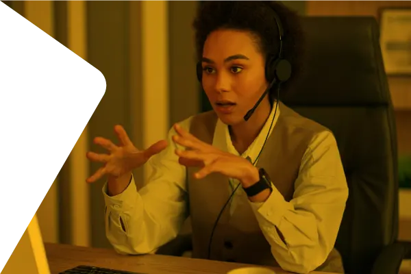 A diverse woman engaged in a serious conversation, wearing headphones