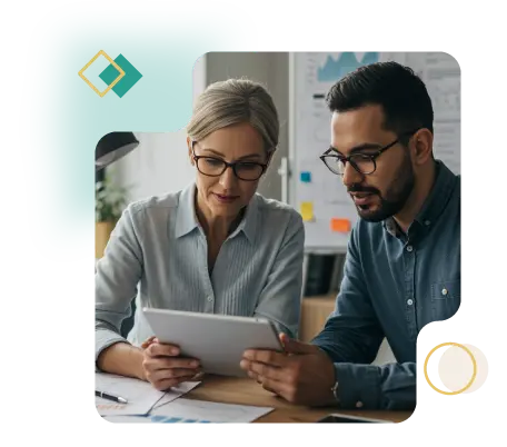 Two senior HR professionals reviewing data on a tablet in a modern office, collaborating over business charts and notes, with inclusive and professional atmosphere.