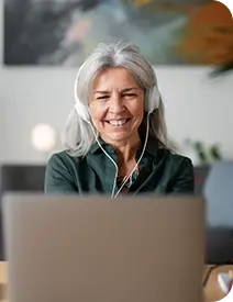 Smiling senior HR leader participating in a virtual peer-to-peer session with headphones on