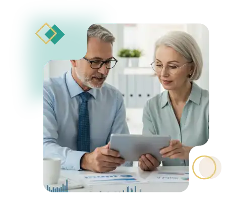  Two experienced VP-level professionals reviewing payroll reports together on a tablet in a bright, modern office environment