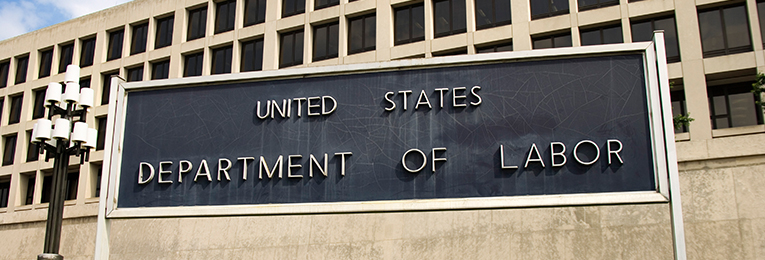 An image featuring the words "Department of Labor", prominently displayed in front of a building.