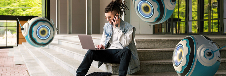 a man seen talking on a moble phone and working in his laptop