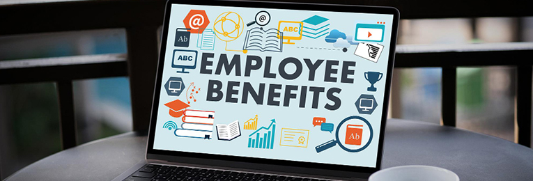 "Employee Benefits" displayed on a laptop screen, with relevant icons floating around, symbolizing healthcare, wellness, retirement plans, and workplace perks.
